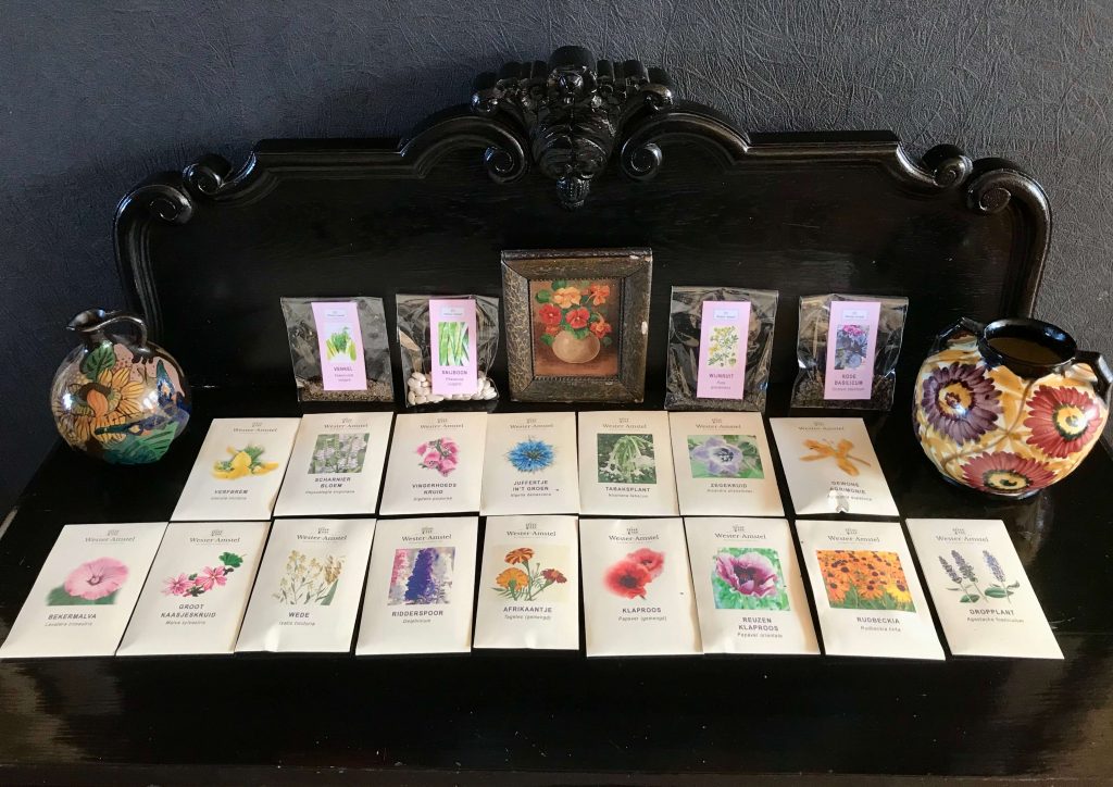 Wester-Amstel vegetable and flower seed packets, sitting on a table in rows